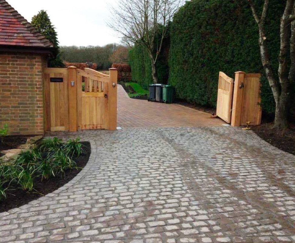 Photo of a custom designed driveway and wooden gate.